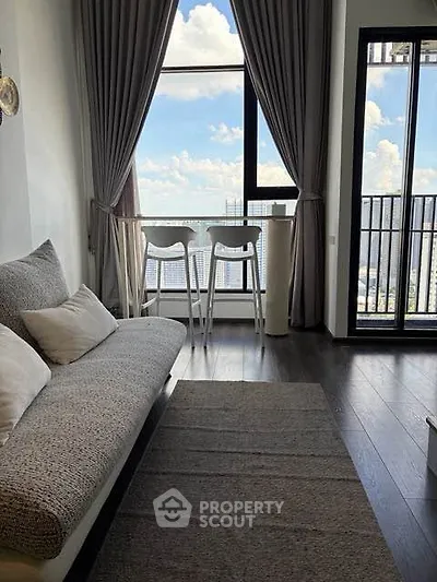 Modern living room with stunning city view and cozy seating area.