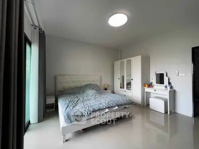 Spacious bedroom with modern furnishings and natural light
