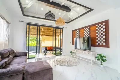 Stunning modern living room with stylish decor and spacious layout, featuring large windows and elegant furnishings.