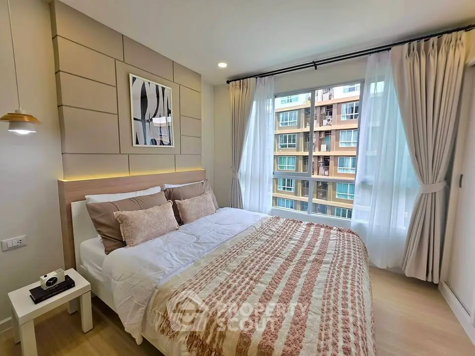 Modern bedroom with large window and stylish decor in urban apartment
