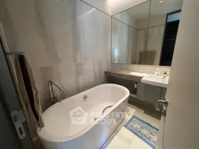Luxurious bathroom with elegant bathtub and modern fixtures, perfect for relaxation.