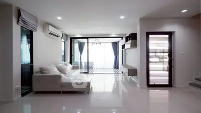 Spacious modern living room with large windows and sleek design