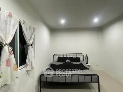 Cozy minimalist bedroom with modern metal bed frame and soft lighting