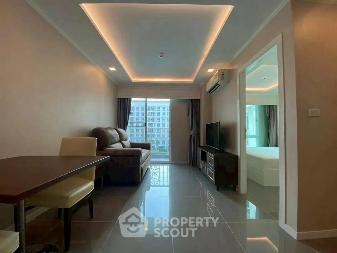 Modern living room with sleek furniture and ambient lighting in a stylish apartment.