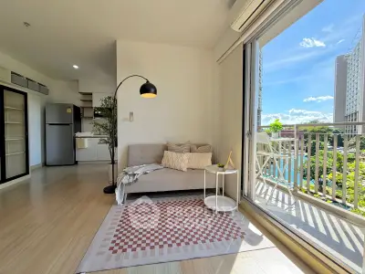 Bright modern living room with balcony view in high-rise apartment