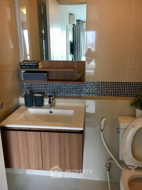 Modern bathroom with sleek vanity and stylish decor in a contemporary apartment.