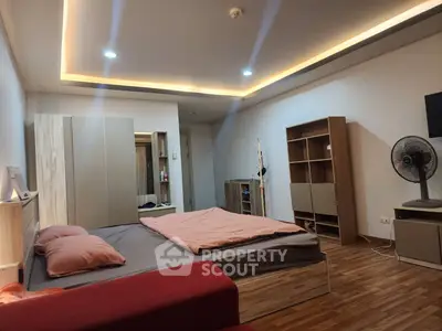 Spacious modern bedroom with stylish furniture and ambient lighting