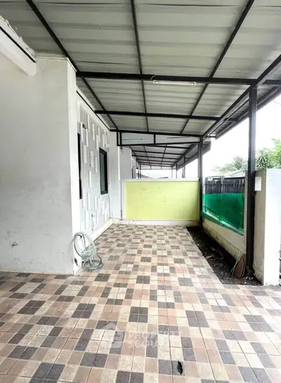 Spacious covered patio with tiled flooring and modern design, perfect for outdoor relaxation.