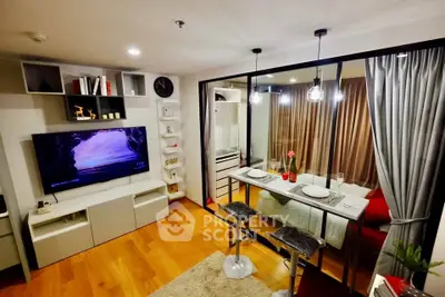 Modern living room with open kitchen, stylish decor, and cozy dining area.