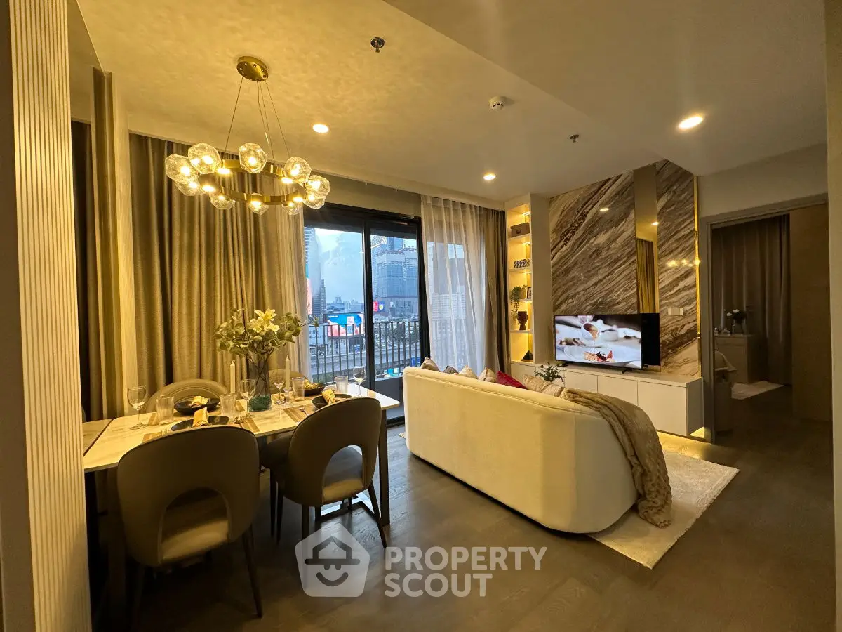 Luxurious living room with elegant decor and city view balcony in modern apartment.