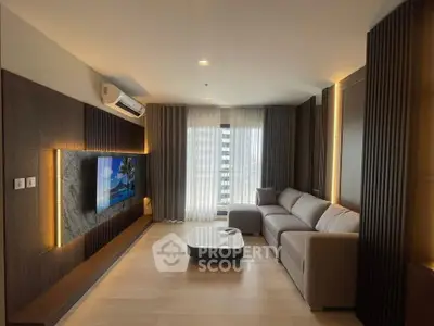 Modern living room with sleek design, large TV, and comfortable sofa in a stylish apartment.