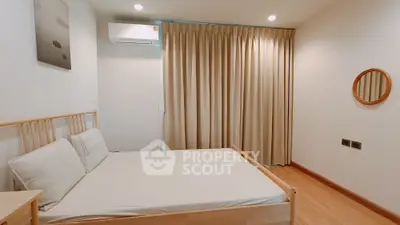 Cozy minimalist bedroom with wooden flooring and neutral curtains