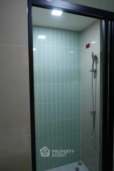 Modern bathroom shower with sleek tile design and contemporary fixtures.