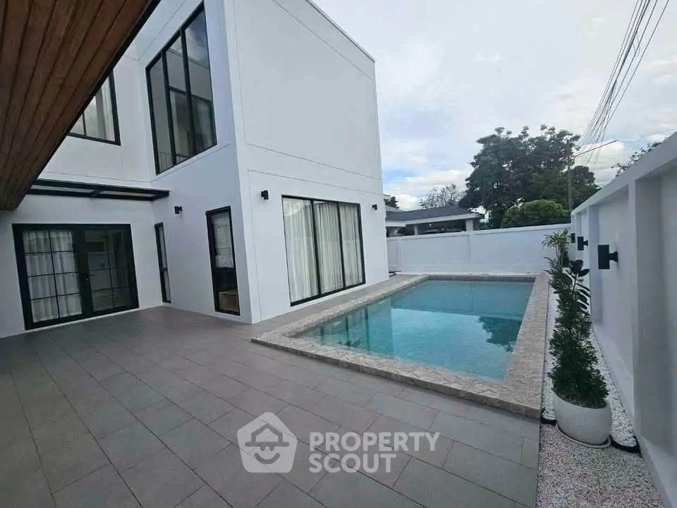 Modern minimalist home with private pool and spacious patio area.