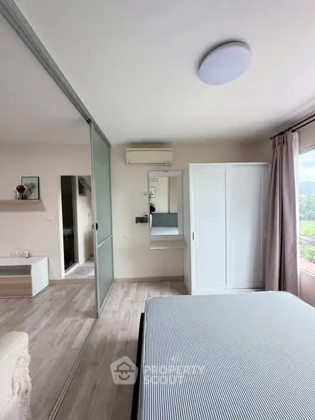 Modern bedroom with sliding glass doors and scenic window view