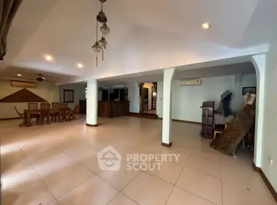 Spacious open-plan living area with dining space and modern lighting, perfect for entertaining.