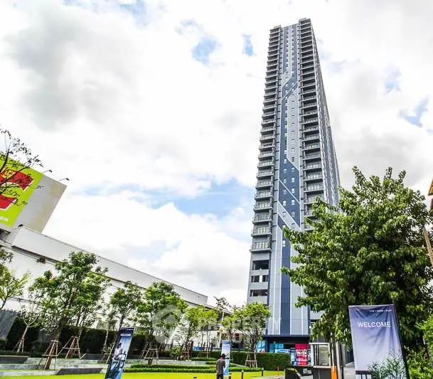 Stunning high-rise building with modern architecture and lush green surroundings.