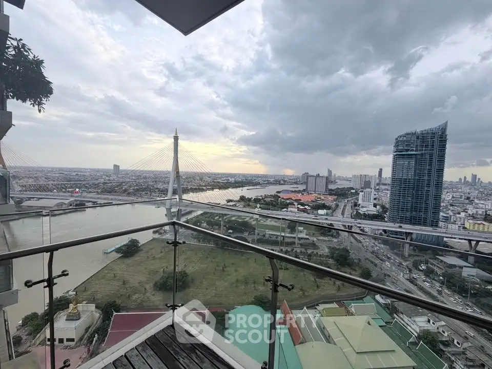 Stunning cityscape view from a high-rise balcony overlooking a river and modern skyline.
