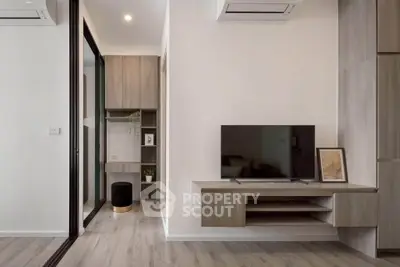 Modern living room with sleek TV setup and stylish wooden flooring