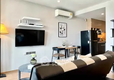 Modern living room with sleek black and white decor, wall-mounted TV, and compact dining area.