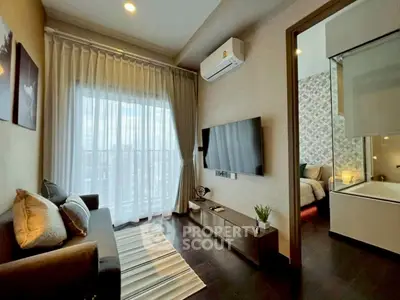 Modern living room with elegant decor and natural light, featuring a cozy sofa and wall-mounted TV.