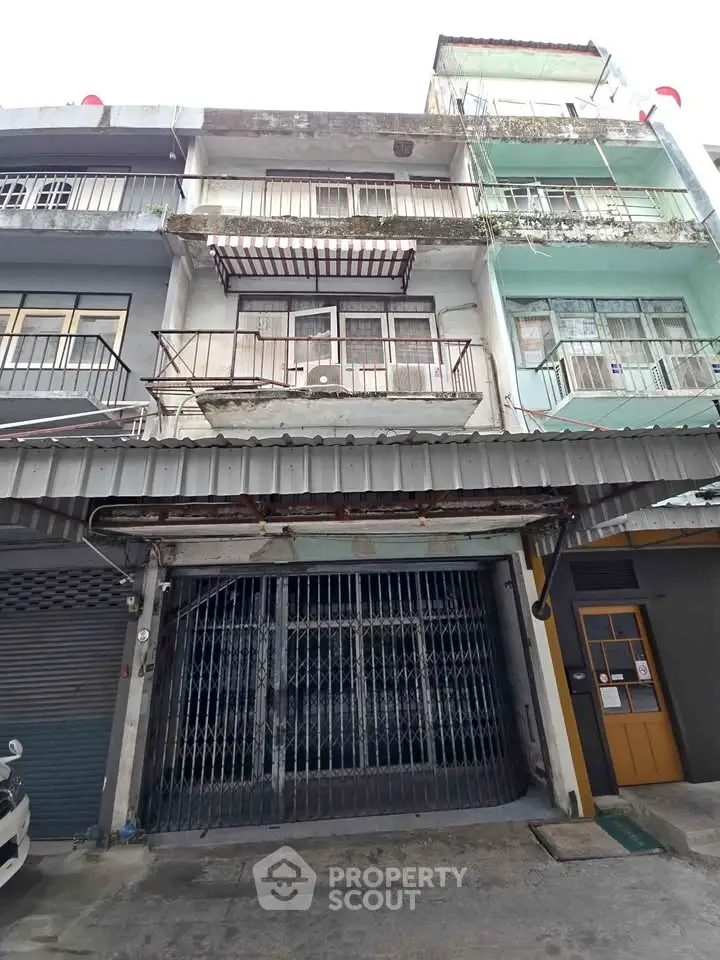 Charming multi-story building with unique architectural details and potential for renovation.