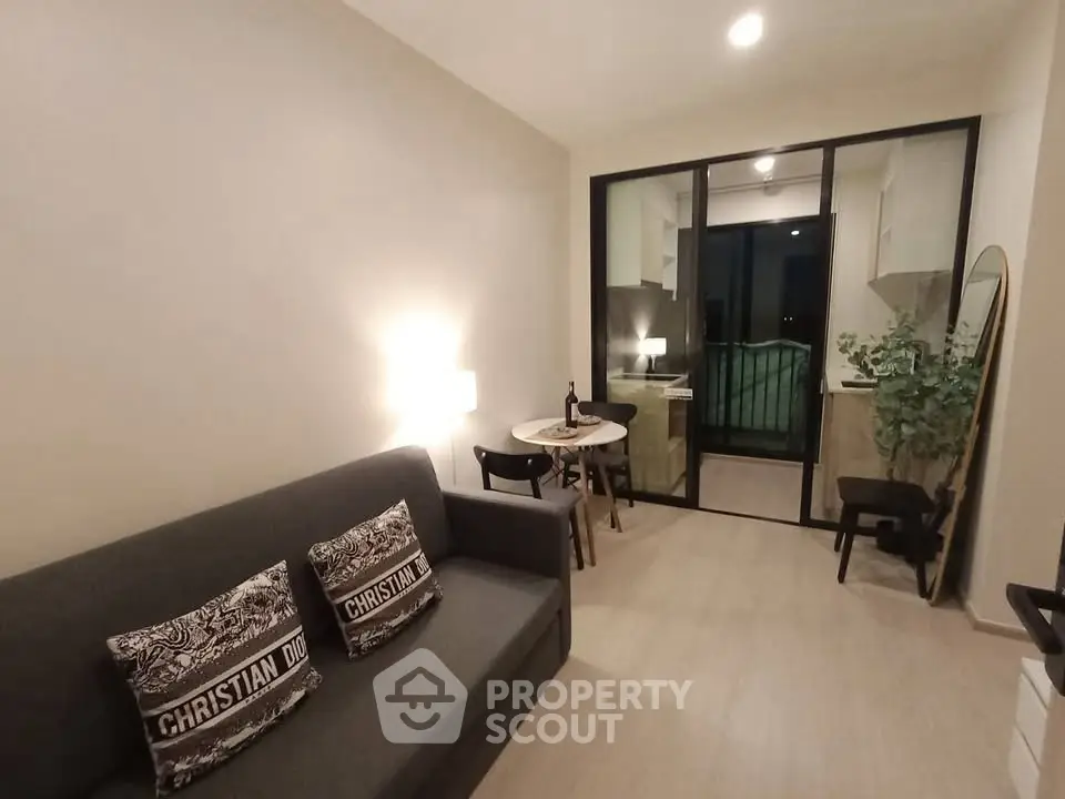 Modern living room with cozy sofa and dining area in open layout apartment.