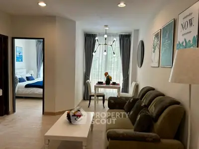 Chic living room with elegant decor and cozy bedroom view, perfect for modern urban living.