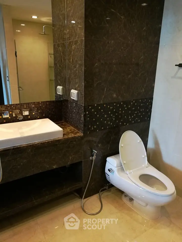 Luxurious bathroom with elegant marble finishes and modern fixtures in a high-end property.