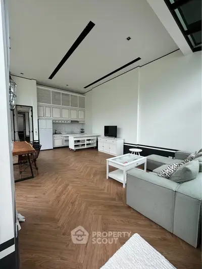 Spacious modern living room with high ceiling and elegant wooden flooring