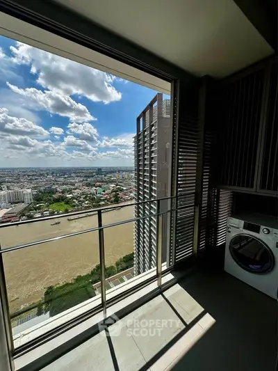 Stunning high-rise balcony with river view and in-unit washing machine, perfect for urban living.