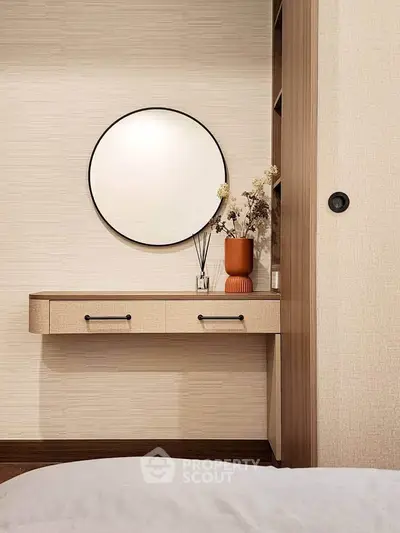 Elegant bedroom with stylish round mirror and modern decor