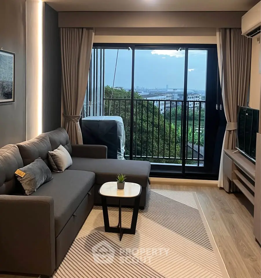 Modern living room with large window and scenic view, featuring stylish furniture and elegant decor.