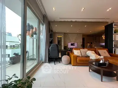 Luxurious living room with modern decor and spacious balcony view