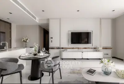 Modern living room with sleek design, featuring a wall-mounted TV, elegant dining area, and stylish decor.