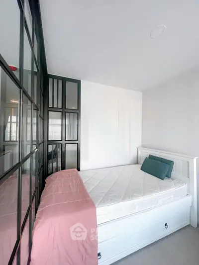 Modern bedroom with stylish glass partition and cozy bed setup