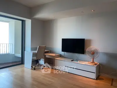 Modern living room with sleek furniture and balcony access