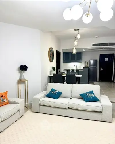 Modern living room with elegant lighting and open kitchen layout
