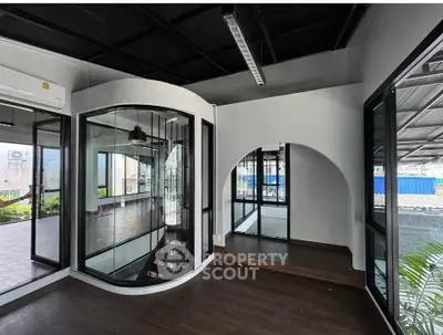 Modern interior with unique glass walls and wooden flooring, perfect for stylish urban living.