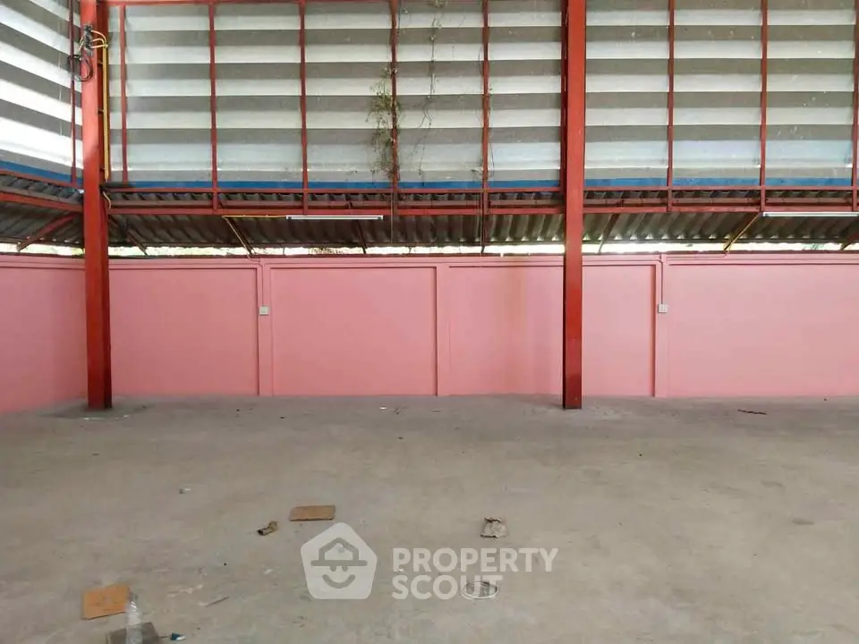Spacious industrial warehouse with high ceilings and ample natural light.