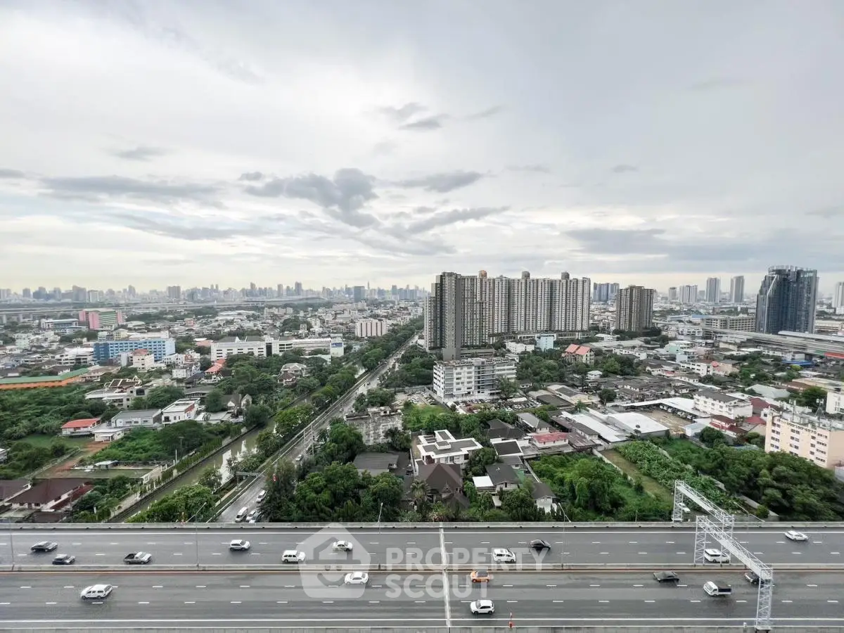 Stunning cityscape view from high-rise building showcasing urban skyline and highway.