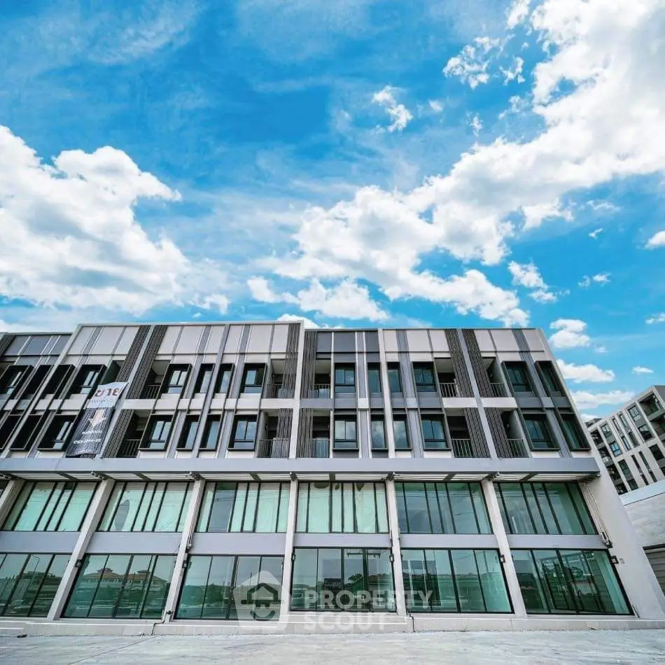 Modern architectural building with large windows and blue sky backdrop