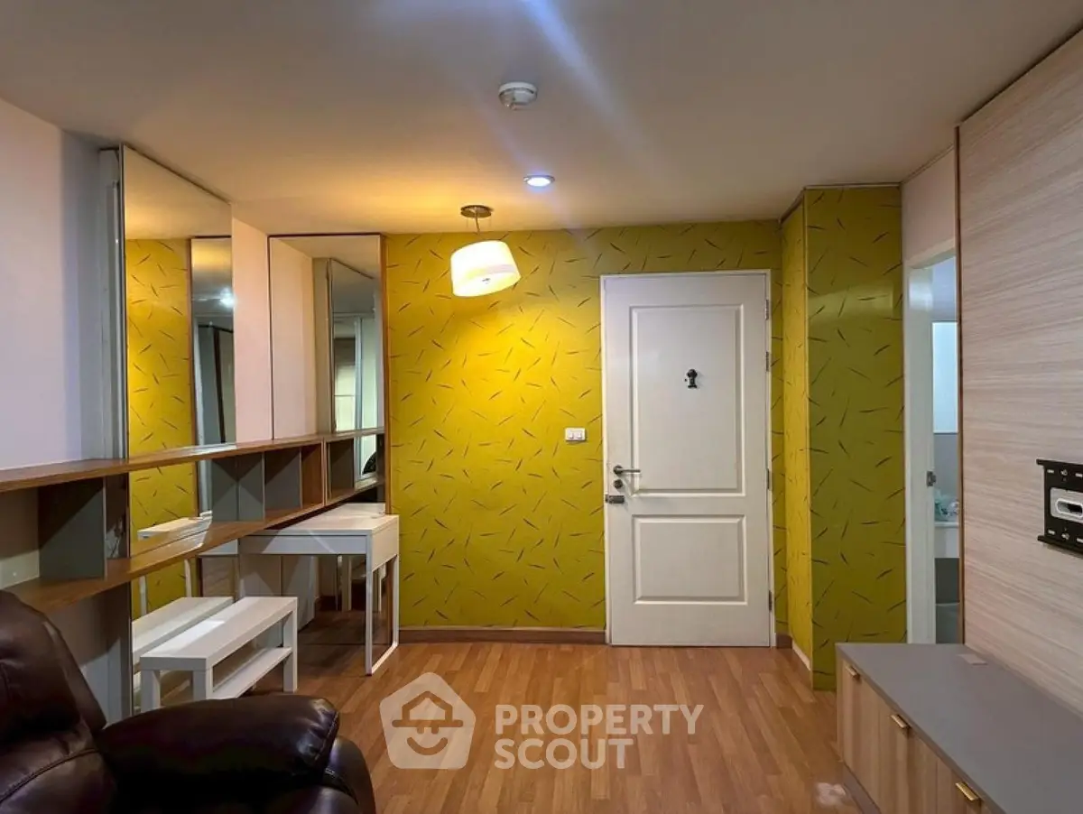 Modern living room with stylish yellow accent wall and sleek wooden flooring