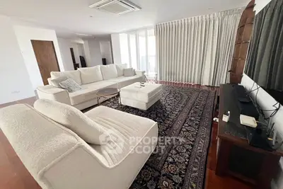 Spacious living room with elegant decor and large windows in a modern apartment.