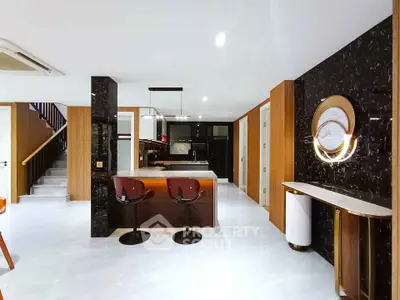 Luxurious modern kitchen with sleek marble accents and stylish bar seating