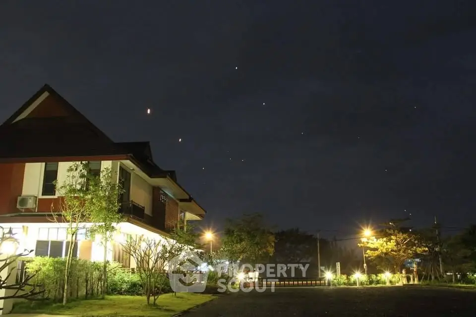 Charming suburban house with lush garden under a starry night sky, perfect for serene living.