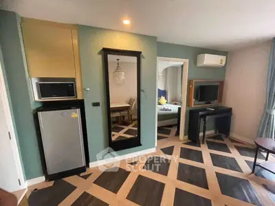 Chic modern living room with stylish flooring and compact kitchen area, perfect for urban living.