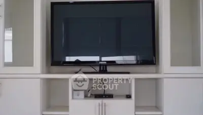 Modern living room with sleek TV setup and elegant cabinetry
