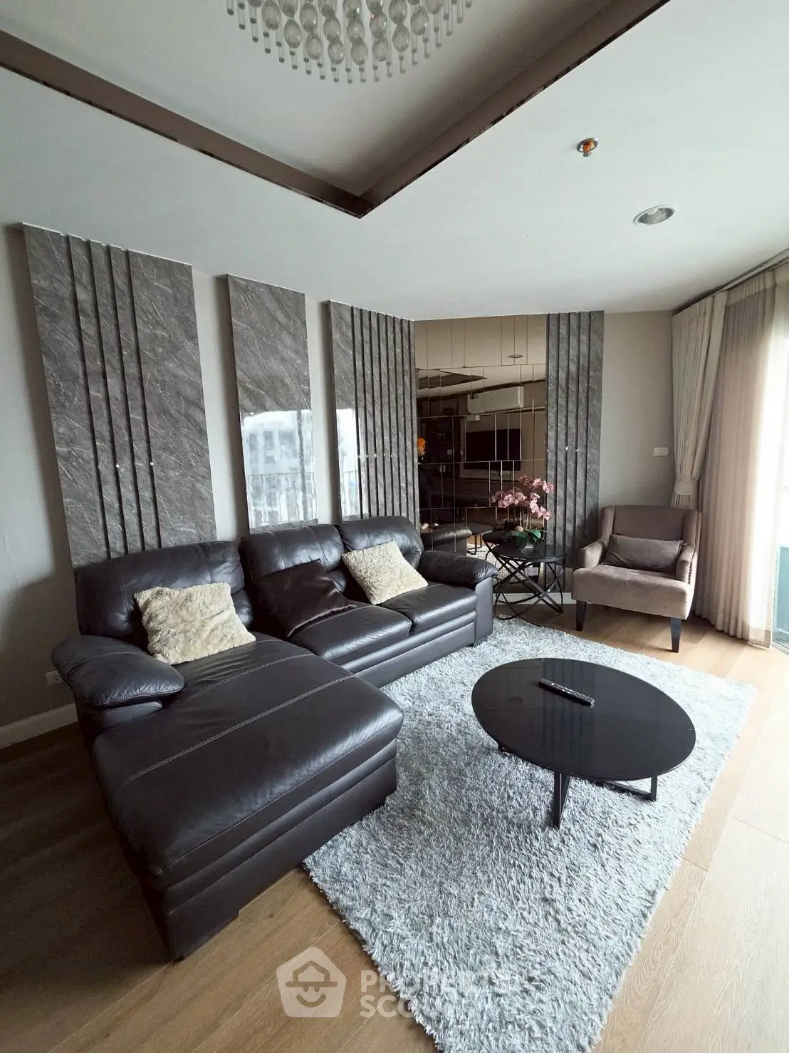 Luxurious living room with modern decor, leather sofa, and elegant lighting in a stylish apartment.