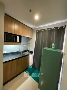 Compact modern kitchen with sleek cabinets and appliances